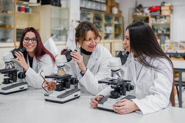 Wissenschaftlerinnen benutzen Mikroskope im Labor - ADSF12418