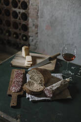 Fresh salami sausage with homemade bread and wine on table in cellar - ALBF01423