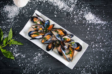 Steamed mussels with Thai sauce in white plate - ADSF12540