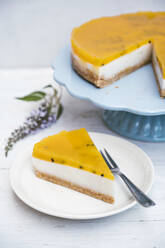 Slice of layered tart with crumble crust, coconut milk, custard and passion fruit top - IPF00547