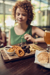 Woman having tapas in a pub - ZEDF03665