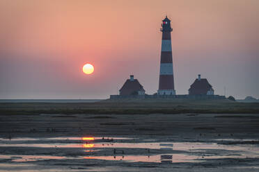 Germany, Schleswig-Holstein, Westerhever, Westerheversand Lighthouse at sunrise - KEBF01616