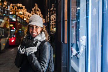 Smiling woman in the city of London in winter - JMPF00377