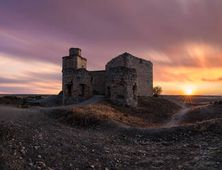 Sightseeing medieval ruined castle against cloudy sundown sky in countryside in Toledo - ADSF12659