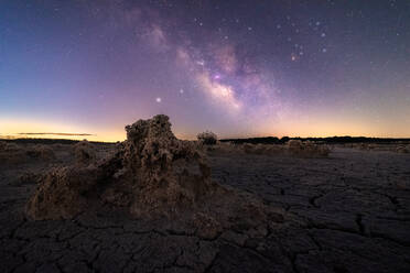 Majestic scenery of volcanic terrain with porous rocks and colorful Milky Way on background - ADSF12754