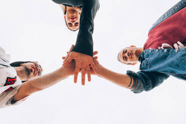 Group of young people putting hands together - ADSF12779