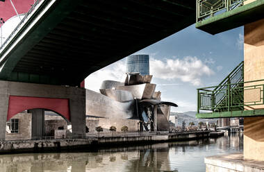 View of channel and bridge with Guggenheim Bilbao Museum on other side of river in daylight - ADSF12828