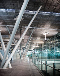 Interior of contemporary building hallway with white pillars and glass walls - ADSF12839