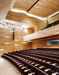 Spacious stylish auditorium with bright illumination and empty comfortable seats inside contemporary theater - ADSF12898