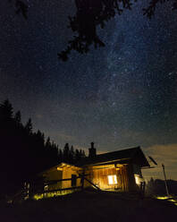 Starry night sky over secluded mountain hut - MALF00161