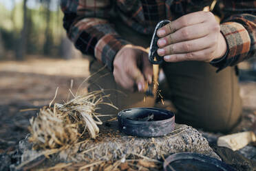 Bushcrafter preparing fire in forest - SASF00029