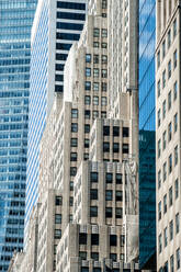 Details of glass facades of tall contemporary skylines during daytime in New York - ADSF13391