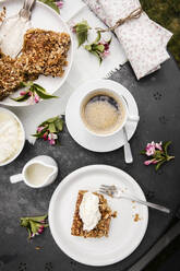Cup of coffee and homemade rhubarb cake on garden coffee table - EVGF03730