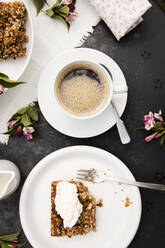 Cup of coffee and homemade rhubarb cake on garden coffee table - EVGF03732
