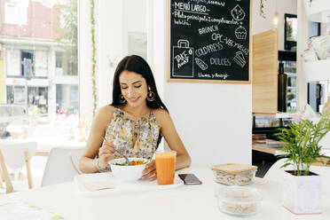 Cheerful woman with healthy food in cafe - ADSF13612