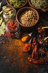 Top view composition with different kinds of natural aromatic spices placed on slate surface background - ADSF13768