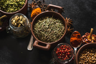 Top view composition with different kinds of natural aromatic spices placed on slate surface background - ADSF13771