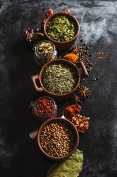 Top view composition with different kinds of natural aromatic spices placed on slate surface background - ADSF13772