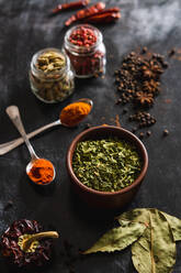 Top view composition with different kinds of natural aromatic spices placed on slate surface background - ADSF13773