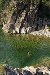 Frau schwimmt im Fluss Solenzara - UMF00974