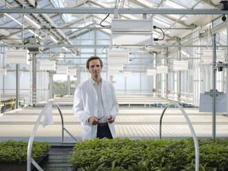 Portrait of a confident scientist in a greenhouse - JOSEF01588