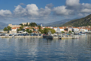 Greece, North Aegean, Pythagoreio, Clouds over harbor of coastal town in summer - RUNF04155
