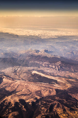 Aerial view of brown barren mountains at dusk stock photo