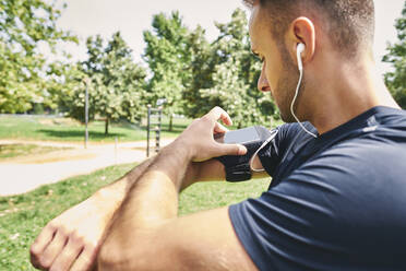 Sportsman looking at his smart phone - CAVF88654