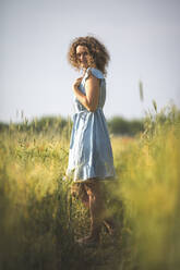 Woman smiling while standing in agricultural field - ASCF01455