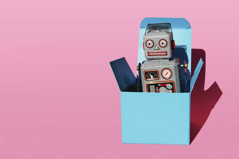 Studio shot of vintage robot toy in turquoise gift box - GEMF04102