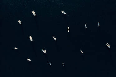 From above of various modern motor boats floating on calm surface of sea during sunny day - ADSF14105