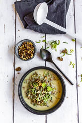 Bowl of vegetarian leek soup with cheese and roasted walnuts - SARF04624
