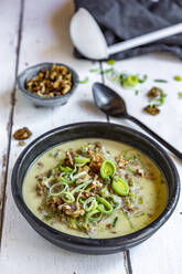 Bowl of vegetarian leek soup with cheese and roasted walnuts - SARF04625