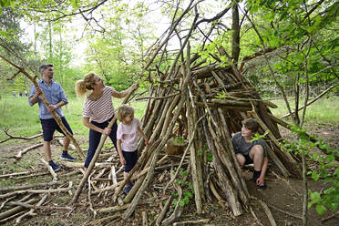 Family building camp together with log in forest - ECPF01046