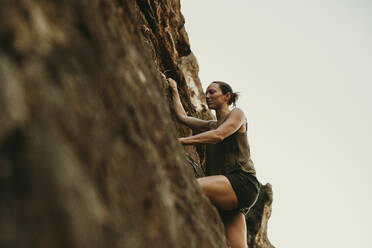 Woman climbing rock mountain - DMGF00126