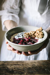 Faceless person with breakfast bowl with quinoa, rice and groats - ADSF14277