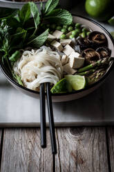 Served Pho soup with noodles on marble and wood board - ADSF14333