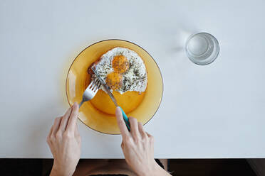 Young woman in lingerie having breakfast by the table - CAVF88724