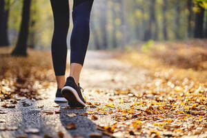 Junge Frau joggt im Herbstwald - BSZF01671