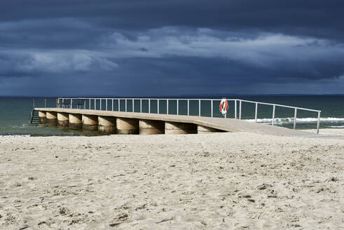 Empty jetty at beach against cloudy sky - JEDF00332