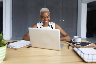 Businesswoman working in modern office, using laptop - VABF03367