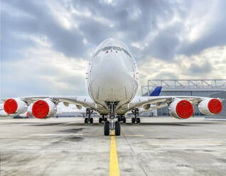 Airbus parked on runway at airport against sky - WEF00475