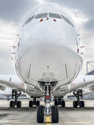 Airplane on runway at airport against sky - WEF00476