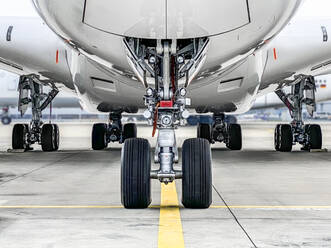 Below view of airplane tyres on runway at airport - WEF00478