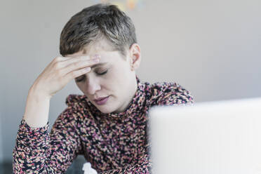 Portrait of businesswoman having headaches - UUF21114