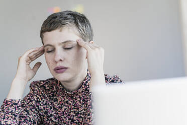 Portrait of businesswoman having headaches - UUF21115