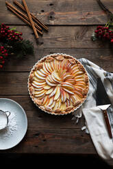 Tasty apple pie on a wooden table ready to eat near empty plate - ADSF14535