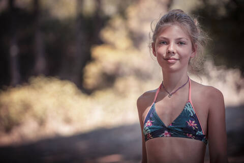 Girl smiling while standing at beach stock photo