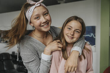 Close-up of smiling friends standing at home - MFF06089