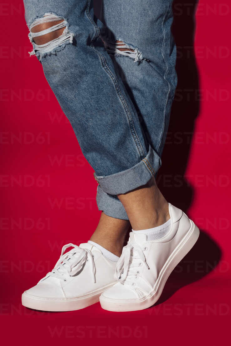 Woman Wearing White and Blue Pants and Pair of Gray-and-white Low-top  Sneakers · Free Stock Photo